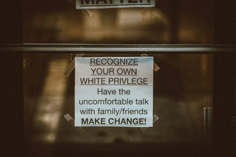 a sign that reads "recognize your own white privilege have the uncomfortable talk with family/friends make change!"